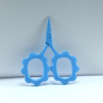 Sunflower-shaped embroidery scissors in light blue powder coating, 2.5'' forged stainless steel, designed for precise and decorative cutting.