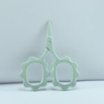 Sunflower-shaped embroidery scissors in aqua green powder coating, 2.5'' forged stainless steel, designed for precise thread cutting and detailed needlework.