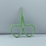 2.5-inch mint-colored heart-shaped embroidery scissors made of stainless steel, designed for fine thread trimming and delicate handwork.