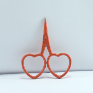 2.5-inch heart-shaped embroidery scissors in orange powder coating with stainless steel blades, ideal for thread cutting and fine sewing tasks.