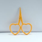 2.5-inch yellow heart-shaped embroidery scissors made from forged stainless steel, ideal for thread cutting and fine embroidery work.