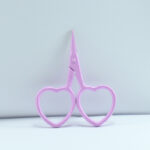 2.5-inch lilac heart-shaped embroidery scissors with stainless steel blades, designed for fine needlework and thread cutting.