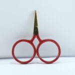 2.5-inch Big Ring Tiny Scissors with gold blade and red handle, forged stainless steel, large finger rings for comfort and precision in embroidery and crafts.